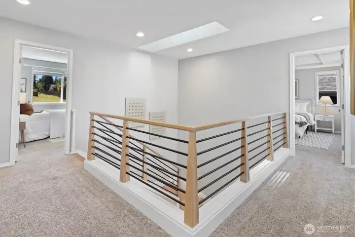 Upstairs landing connecting primary on opposite wing to additional bedrooms
