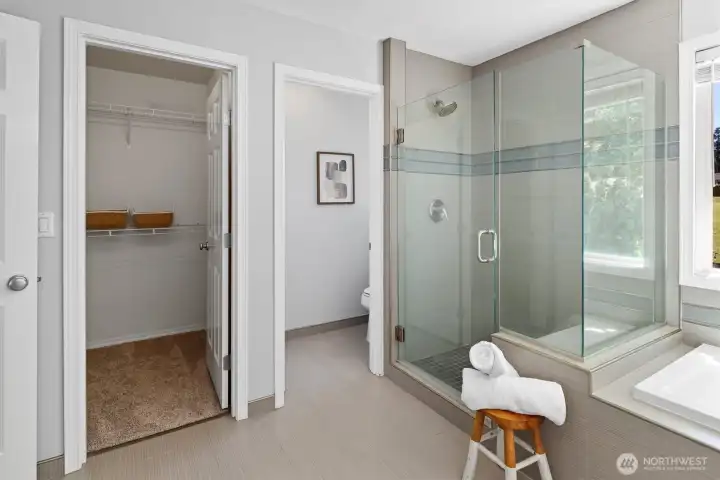 Primary 5 piece ensuite bathroom with dual vanities, large soaking tub, toilet closet and walk-in closet (2nd closet)