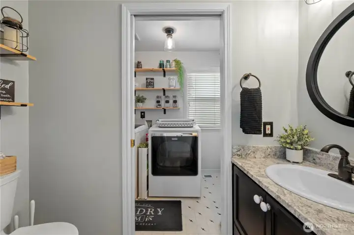 Main floor half bath- pocket door separates laundry room Main floor half bath- pocket door separates laundry room