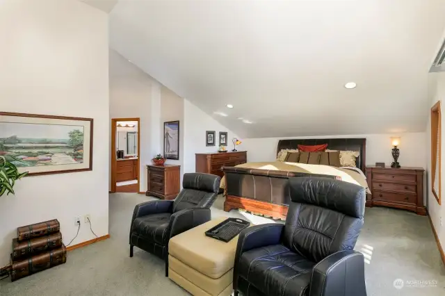 Upper level primary suite with spacious sitting and work area plus large walk-in closet