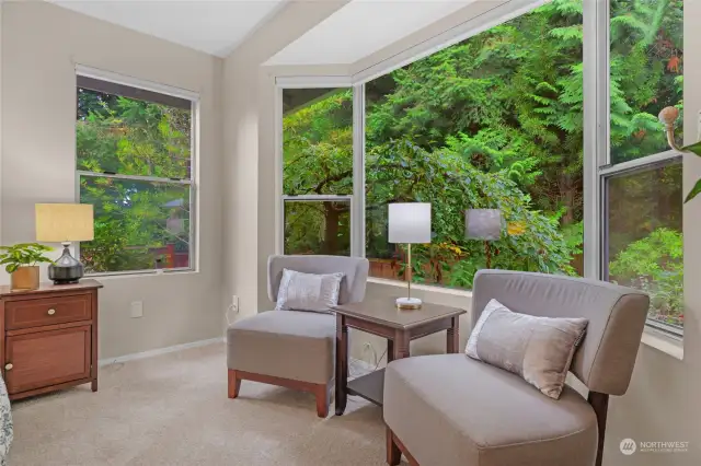 Large windows fill the room with natural light.  Electric blinds.