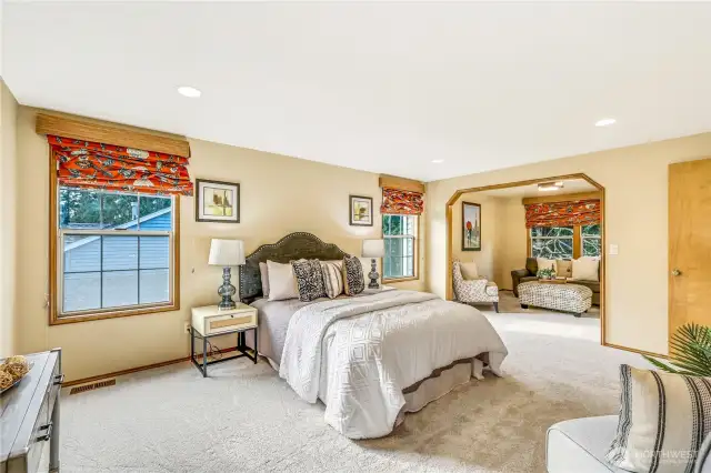 A unique feature of the primary suite, this extra sitting area can be used as a reading nook, office space, or personal lounge. Large windows provide serene views of the neighborhood, enhancing the sense of tranquility.