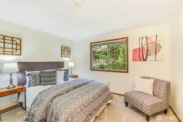 Secondary bedrooms are well-sized, featuring large windows that bring in natural light and views of the lush backyard.