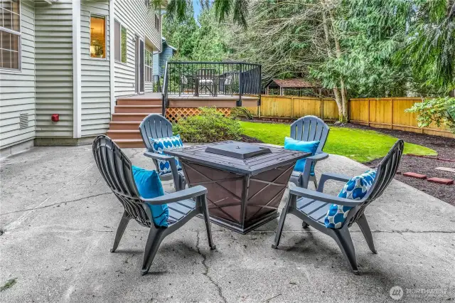 Nestled beneath the towering trees, this cozy patio area is perfect for enjoying cool evenings by a fire. The fully fenced backyard ensures privacy while maintaining a connection to nature.