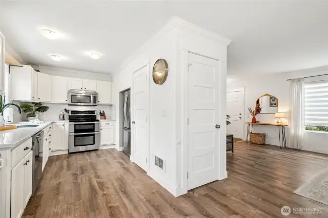 Kitchen features quartz counters, walk in pantry, double oven and stainless steel appliances.