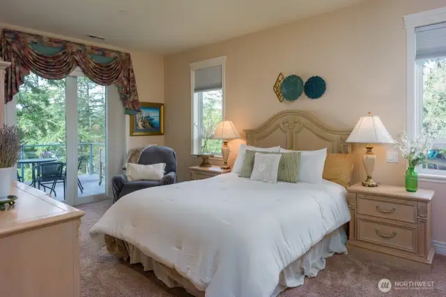 Second primary bedroom, main level, opens to beautiful deck seating.