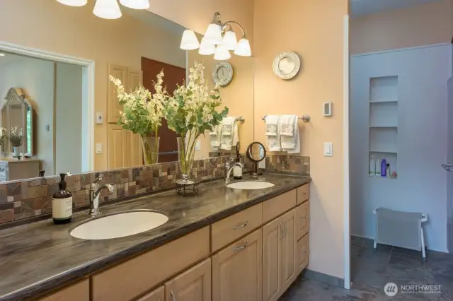 Spacious ensuite bath in second primary bedroom with double sinks and walk in shower. Radiant floors for warm walking.