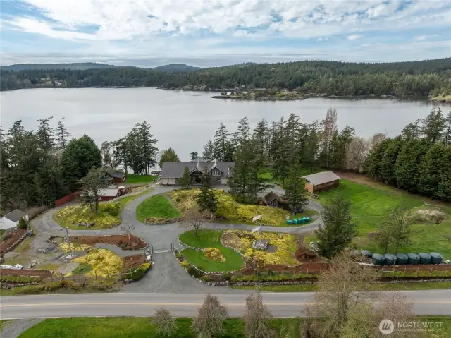 Pass through the gated entry into 4 park-like acres of this magical, waterfront compound.