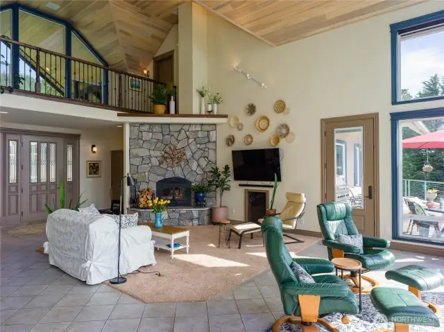 Great room anchored by beautiful stone fireplace.