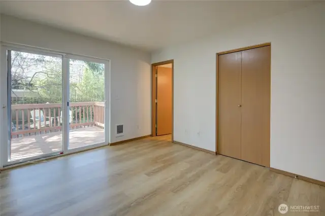 Primary bedroom with bathroom and back deck.