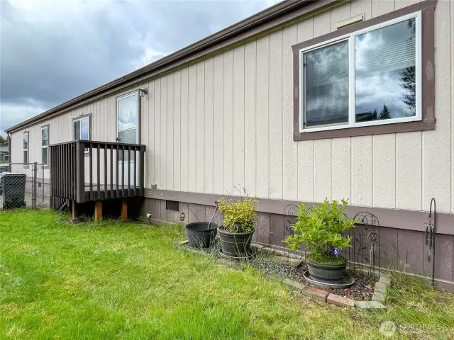 Side yard with steps to laundry room entry