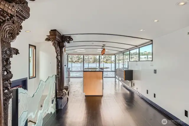 Check out the pillars and etched glass at the top of the foyer from an expansive living room open towards the water through the kitchen and large open space open to the waters edge.