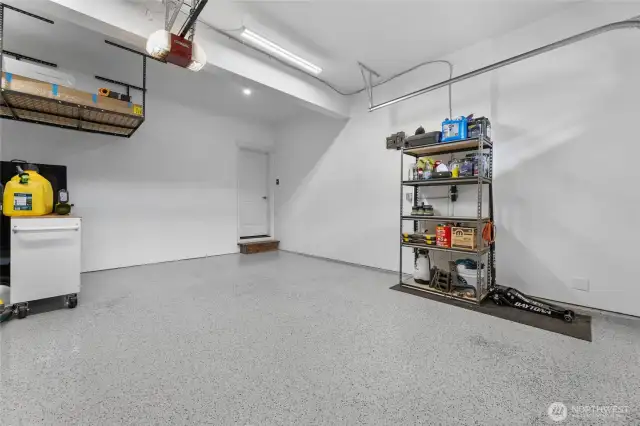 Garage has epoxy flooring and plenty of storage