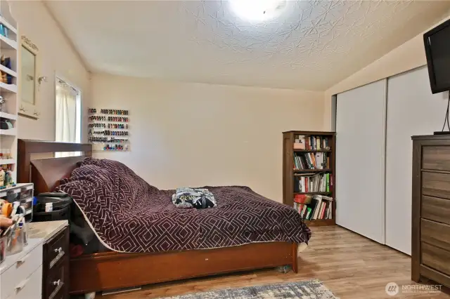 Nice size primary bedroom with light colors.