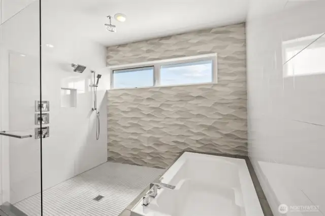 Spacious walk-in shower and soaking tub with lavish detailing.