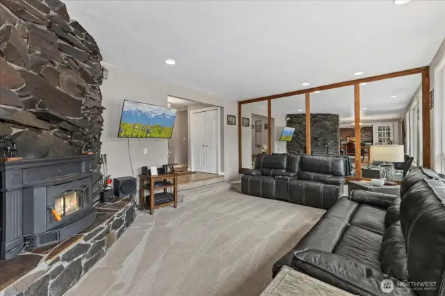 Bright and welcoming living space with abundant natural light, perfect for relaxing in front of the slate fireplace or entertaining.