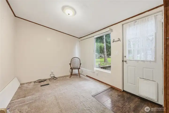 Den/office with door to back deck and covered sitting area.