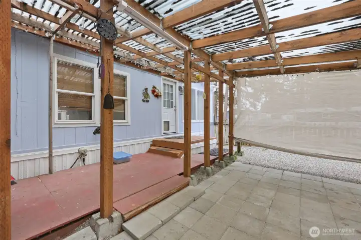 Covered back deck with entrance to den/office.