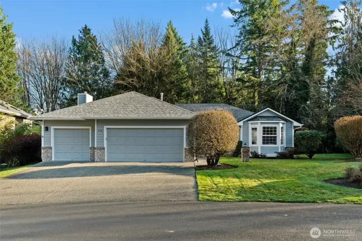 Level driveway with three car garage gives opportunity for great storage and parking availability.