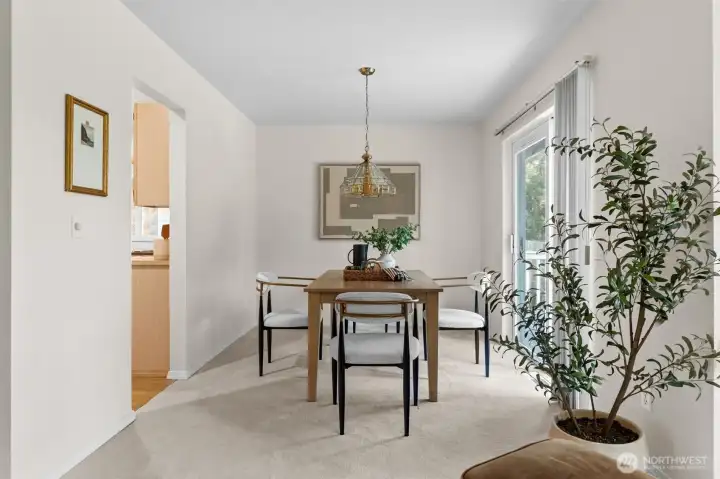 Dining room transitions food to table serving seamlessly with additional access to outdoor patio and backyard space.