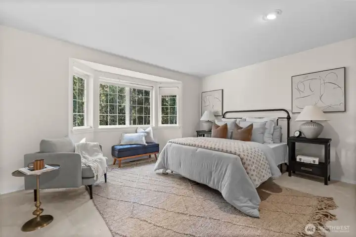 Expansive primary bedroom, with a beautiful window nook to enjoy cozy mornings.