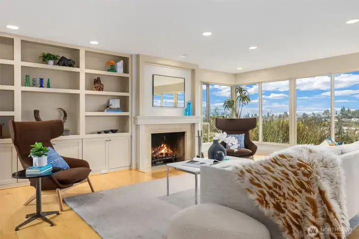 There's even more space for displaying books and art object--with cupboards below--in the additional built-ins to the left of the fireplace.  Additional soft light enters this space through a window looking out upon the entry courtyard (to the left, out of frame in this photo.)