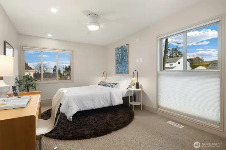 One of two additional spacious bedrooms upstairs.