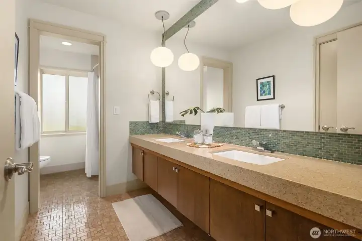 The second bath upstairs features this cool original 1965 vanity and floor tile, with a large frosted gloss offering lovely diffuse light to the tub area.