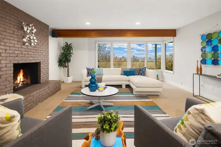 The daylight lower level features this huge family room with wood-burning fireplace and windows looking out toward the backyard and views.  There is gas plumbed to the fireplace for easy conversion.