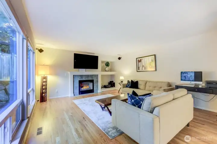 Large family room open from main kitchen with built-ins and gas fireplace! Samsung Smart TV Stays.