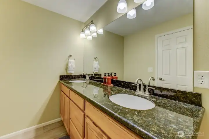 Updated full bath with dual sinks on upper level.