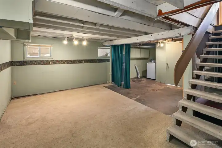 Daylight basement area, partially finished. So many options with all this space!
