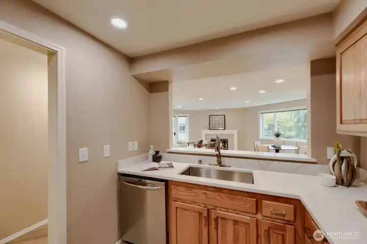 Updated Kitchen - Complete with Window Views from the Sink, Service Bar to Open Living & Dining, Quartz Counters & Stainless Steel Appliances