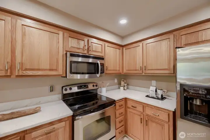Updated Kitchen - Complete with Window Views from the Sink, Service Bar to Open Living & Dining, Quartz Counters & Stainless Steel Appliances