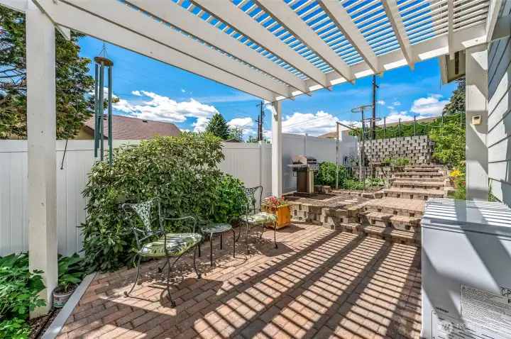 Terraced garden area leading to garage