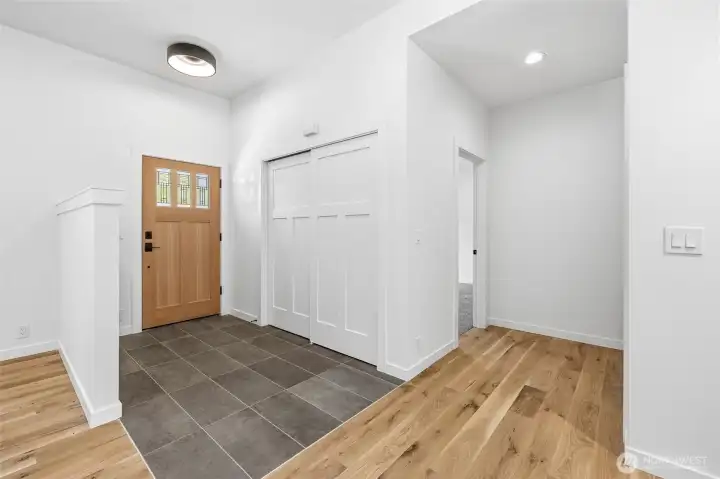 Welcoming entryway with soaring ceilings, modern fixtures, and beautiful wood flooring. Welcoming entryway with soaring ceilings, modern fixtures, and beautiful wood flooring.