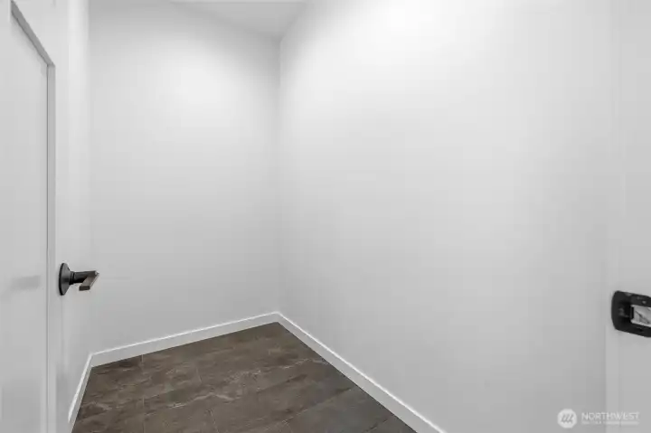 Large walk-in pantry offering exceptional storage and organization space. Large walk-in pantry offering exceptional storage and organization space.