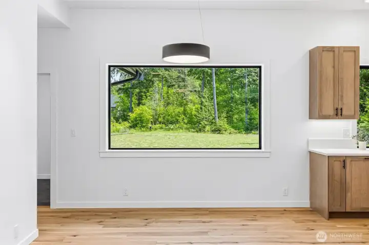 Bright dining area with oversize picture window overlooking the patio and backyard. Bright dining area with oversize picture window overlooking the patio and backyard.