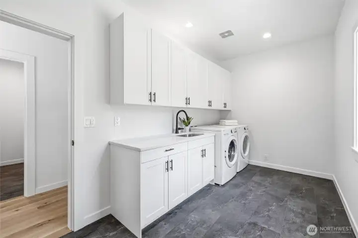 Functional laundry room with full-size washer/dryer and built-in cabinetry. Functional laundry room with full-size washer/dryer and built-in cabinetry.