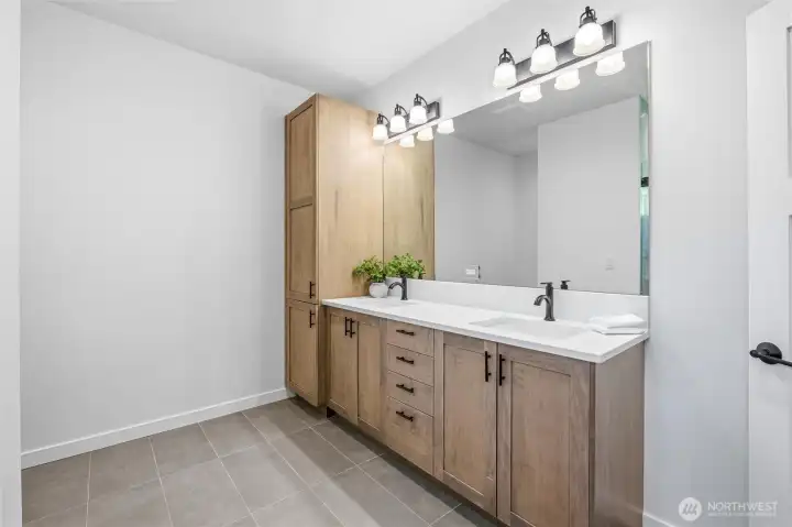 Double vanity bathroom with stylish lighting and ample storage. Double vanity bathroom with stylish lighting and ample storage.