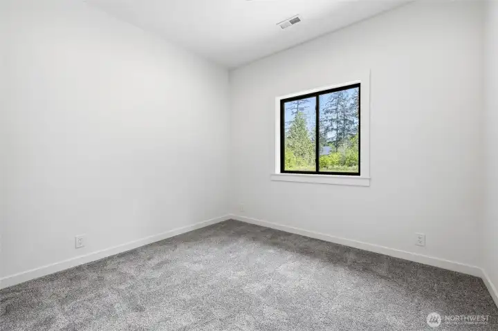 Spacious bedroom with neutral tones and abundant natural light. Spacious bedroom with neutral tones and abundant natural light.