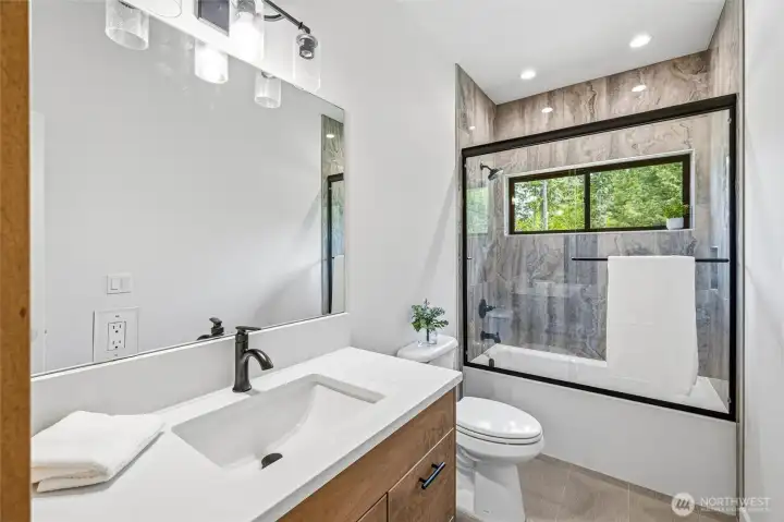 Stylish full bathroom with modern vanity and updated fixtures. Stylish full bathroom with modern vanity and updated fixtures.