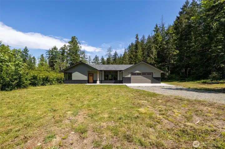 Expansive yard with open green space and surrounding trees for privacy. Expansive yard with open green space and surrounding trees for privacy.