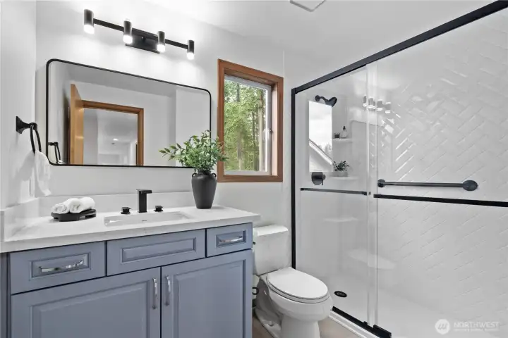 Renovated upstairs bathroom with new shower, vanity, lighting and paint (2026)