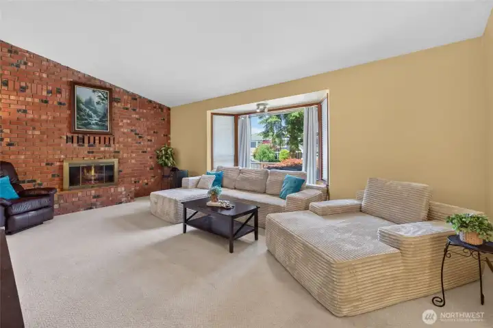 Light and bright home with floor to ceiling fireplace in living room & vaulted ceilings in main living area.