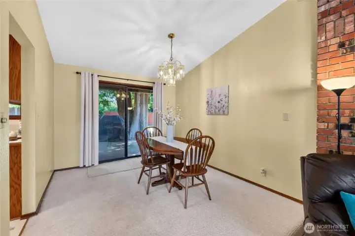 Bright dining area overlooks the backyard and opens directly to the deck, making outdoor dining and summer BBQs effortless