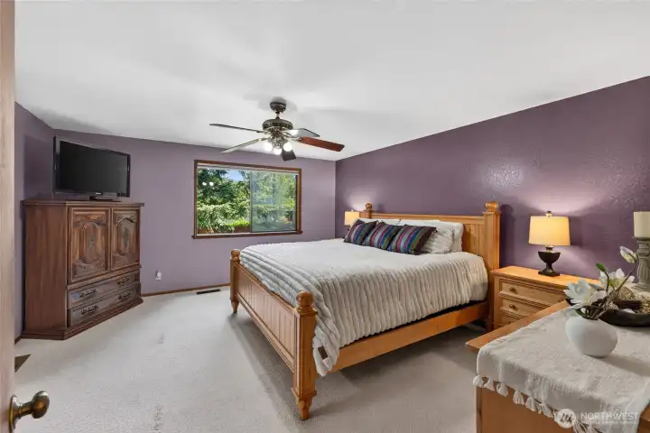 Spacious primary bedroom has 3/4 bath and walk-in closet.
