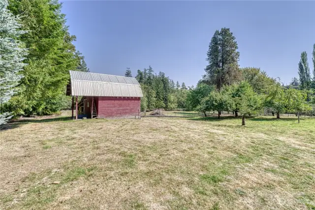 The big red barn feature two stalls, tack room and hay loft. This view if from the deck of the cottage.