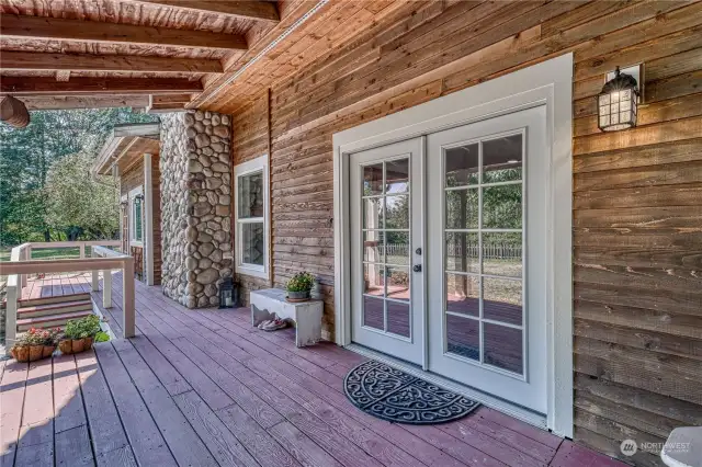 These are the French doors from the kitchen to this very impressive country porch.