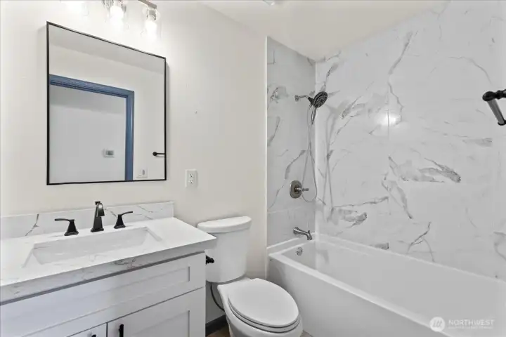 Hall bathroom with full tub.